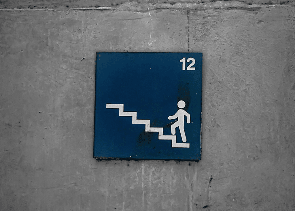 a sign on a premise that shows stairs